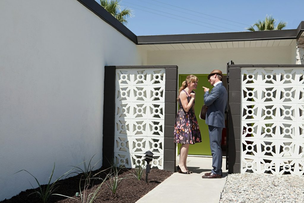 Retro couple outside home